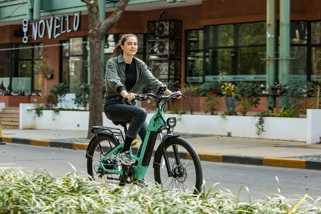Rider on a green electric bike on a city street